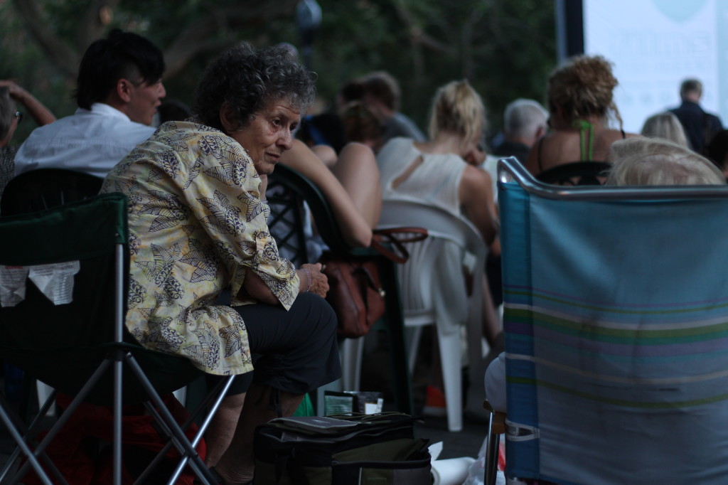 A lady in conversation at Tompkins Square Park on July 5, 2013, waiting to see the French film "L'Arnacoeur."